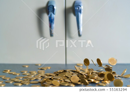 Falling gold coins money on office table with 55163294