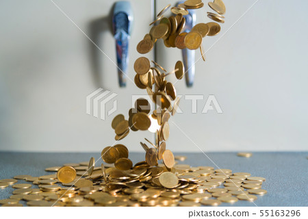Falling gold coins money on office table with 55163296