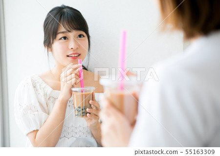 Young girls drinking tapioca milk tea Young girls drinking tapioca milk tea 55163309