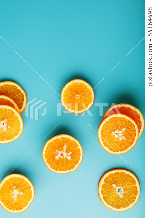 Round slices of juicy orange on a blue background, 55164698