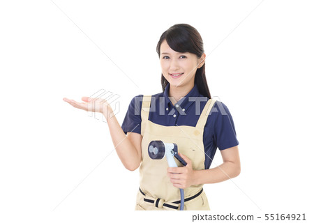 A woman with a smile wearing an apron A woman with a smile wearing an apron 55164921