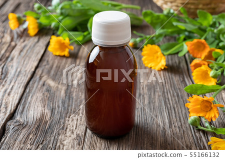 A bottle of calendula tincture with calendula A bottle of calendula tincture with calendula 55166132