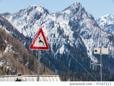 Dolomites nature. A landscape of the mountains and hills - a sign ''deer crossing'' 55167121