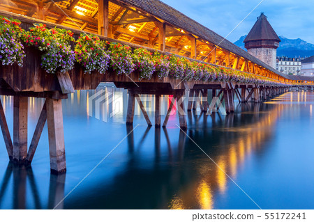 Lucerne. The famous Chapel, Kapellbrucke bridge at dawn in night lighting. Lucerne. The famous Chapel, Kapellbrucke bridge at dawn in night lighting. 55172241