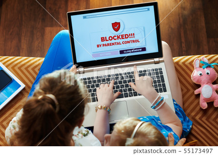 mom and daughter having access restriction by parental control 55173497