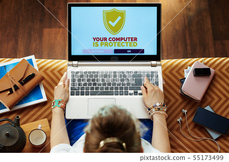 elegant woman using secure and protected laptop 55173499