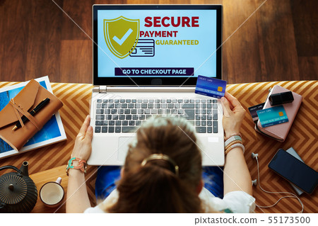 housewife making secure online payments on e-commerce website housewife making secure online payments on e-commerce website 55173500