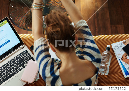 trendy woman using fan while suffer from heat trendy woman using fan while suffer from heat 55173522