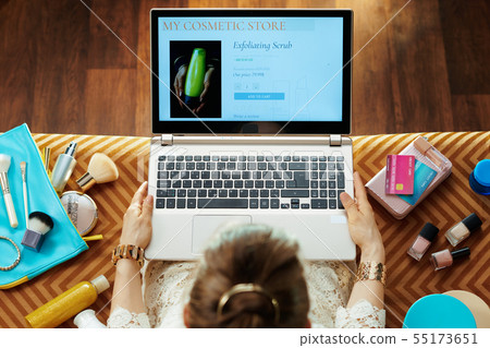modern woman buying makeup while shop online on laptop 55173651