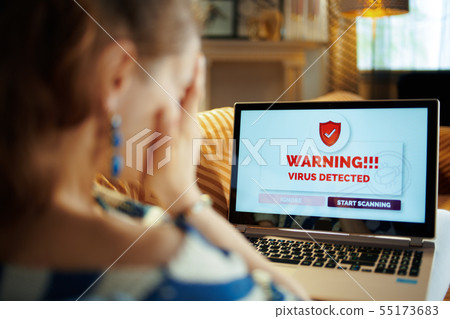sad young housewife having virus on computer 55173683