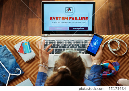 woman having data failure on pc and calling voice tech service 55173684