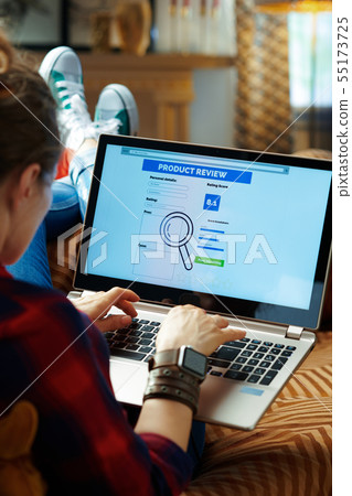 trendy hipster writing review on laptop after online shopping trendy hipster writing review on laptop after online shopping 55173725