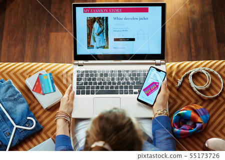 woman browsing high fashion retail online store on laptop woman browsing high fashion retail online store on laptop 55173726
