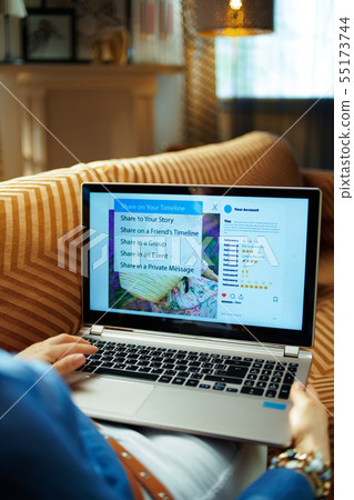 young housewife sharing on social media on laptop young housewife sharing on social media on laptop 55173744