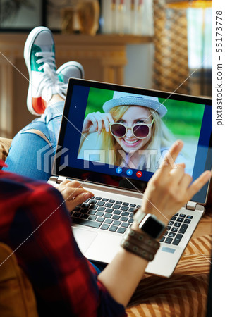 modern hipster using computer for video call on laptop 55173778