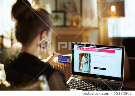 housewife with credit card buying clothes while shop online housewife with credit card buying clothes while shop online 55173802