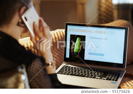 housewife making beauty makeup online shopping on laptop and cal housewife making beauty makeup online shopping on laptop and cal 55173828