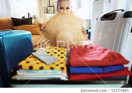 modern woman hiding behind big beach straw hat modern woman hiding behind big beach straw hat 55173905