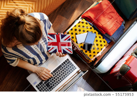woman with Great Britain flag notebook buying airplane ticket 55173953