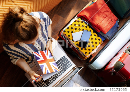 woman with Great Britain flag diary while booking hotel online woman with Great Britain flag diary while booking hotel online 55173965