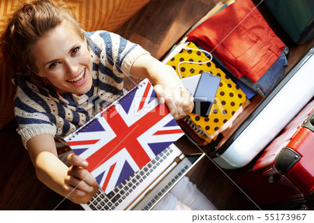 woman showing Great Britain flag notebook while buying ticket woman showing Great Britain flag notebook while buying ticket 55173967