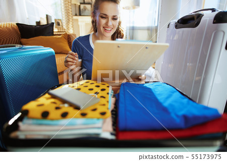 smiling modern tourist woman planning travel smiling modern tourist woman planning travel 55173975