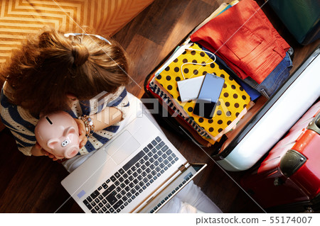 young woman holding piggy bank planning budget summer trip young woman holding piggy bank planning budget summer trip 55174007