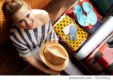 happy woman with straw hat in modern house in sunny summer day happy woman with straw hat in modern house in sunny summer day 55174022