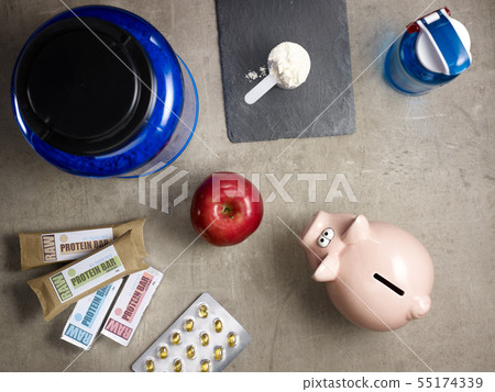 big protein jar, sport supplements in tablets and piggy bank 55174339