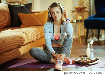 relaxed healthy sports woman listening to music with headphones 55174407