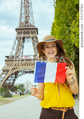 smiling trendy tourist woman showing French flag smiling trendy tourist woman showing French flag 55174761