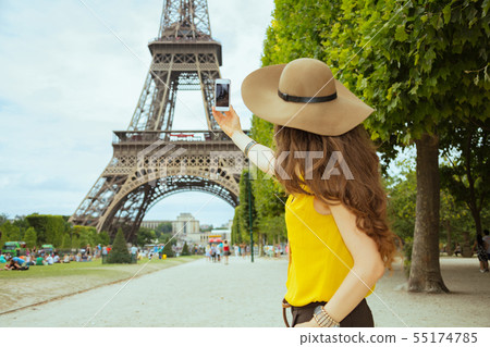 young solo tourist woman taking photo with smartphone young solo tourist woman taking photo with smartphone 55174785