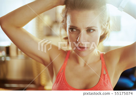 healthy sports woman in modern house adjusting hair healthy sports woman in modern house adjusting hair 55175074