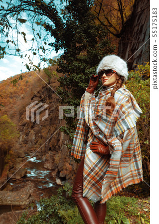 trendy traveller woman outdoors looking into distance trendy traveller woman outdoors looking into distance 55175183