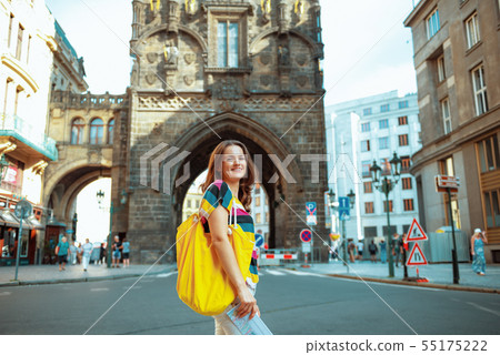 woman hiker in front of Powder Tower in Prague having excursion woman hiker in front of Powder Tower in Prague having excursion 55175222