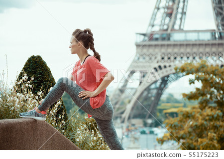 healthy woman jogger in Paris, France stretching healthy woman jogger in Paris, France stretching 55175223