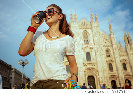 solo traveller woman with colorful shopping bags drinking coffee solo traveller woman with colorful shopping bags drinking coffee 55175304