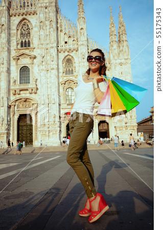 smiling woman with colorful shopping bags looking into distance smiling woman with colorful shopping bags looking into distance 55175343