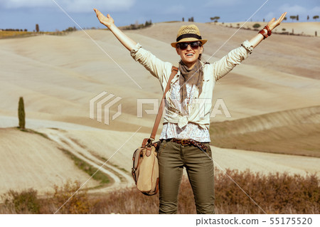 smiling fit woman on summer hiking in Tuscany ,Italy rejoicing 55175520