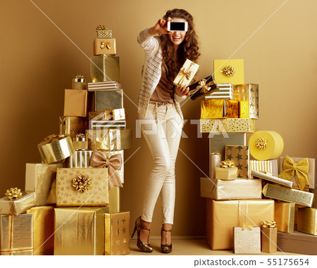shopper woman showing phone blank screen and present boxes shopper woman showing phone blank screen and present boxes 55175654