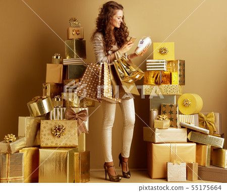 woman with mobile phone examine the price tag with qr code on th woman with mobile phone examine the price tag with qr code on th 55175664