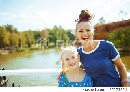 smiling mother and daughter travellers having river voyage smiling mother and daughter travellers having river voyage 55175854
