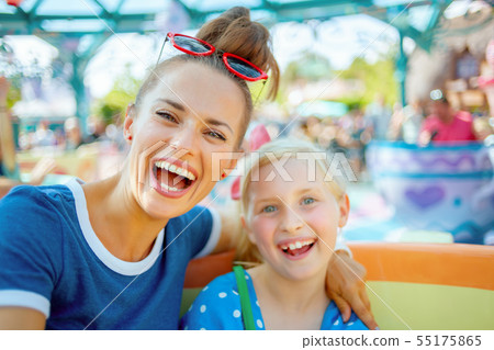 mother and child tourists in theme park enjoying attraction mother and child tourists in theme park enjoying attraction 55175865