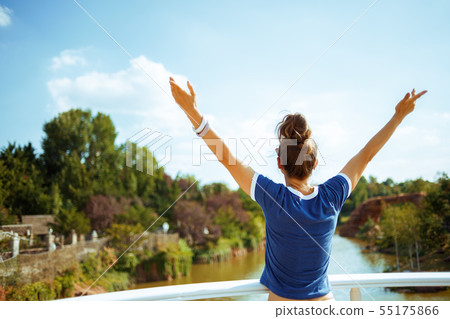 tourist woman on river boat rejoicing while having river voyage tourist woman on river boat rejoicing while having river voyage 55175866