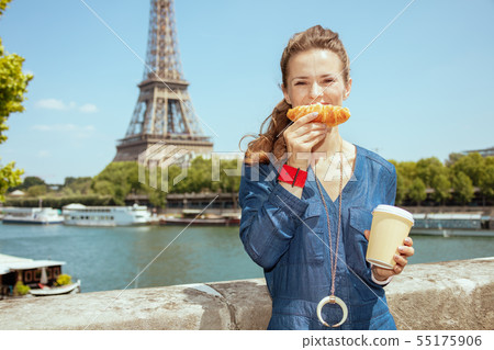 happy woman with cup of coffee making smile with croissant happy woman with cup of coffee making smile with croissant 55175906