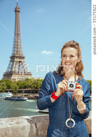 traveller woman with retro photo camera looking into the distanc traveller woman with retro photo camera looking into the distanc 55175922