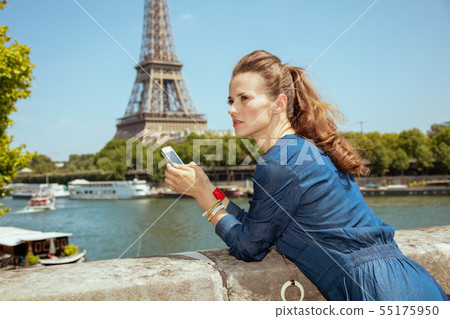 concerned solo tourist woman with smartphone using applications concerned solo tourist woman with smartphone using applications 55175950