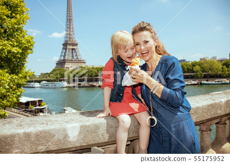 mother and child tourists in Paris, France eating croissant mother and child tourists in Paris, France eating croissant 55175952