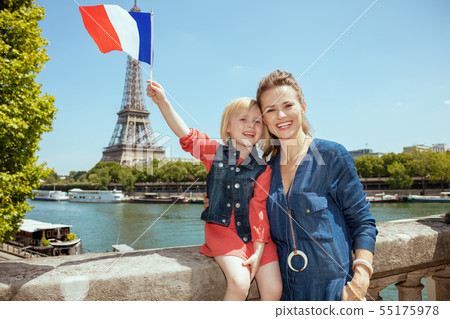 mother and daughter tourists with French flag in Paris, France mother and daughter tourists with French flag in Paris, France 55175978