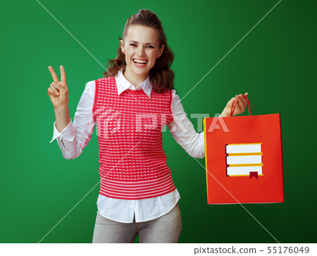 happy student with red shopping bag with books showing victory 55176049